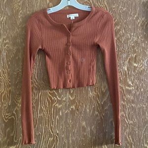 This orange button up is so cute! It can be worn as a shirt or a sweater!